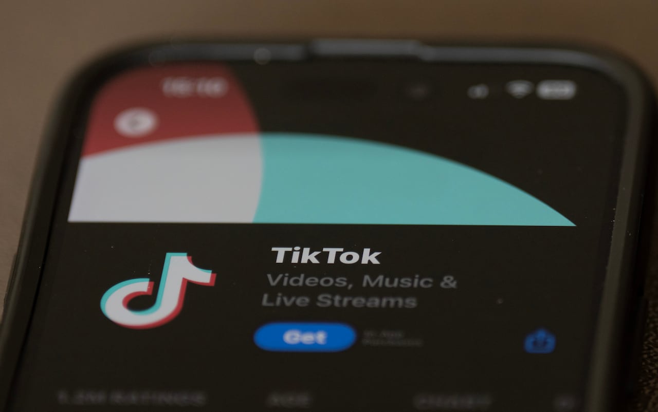 A close of a cell phone with the TikTok app open.