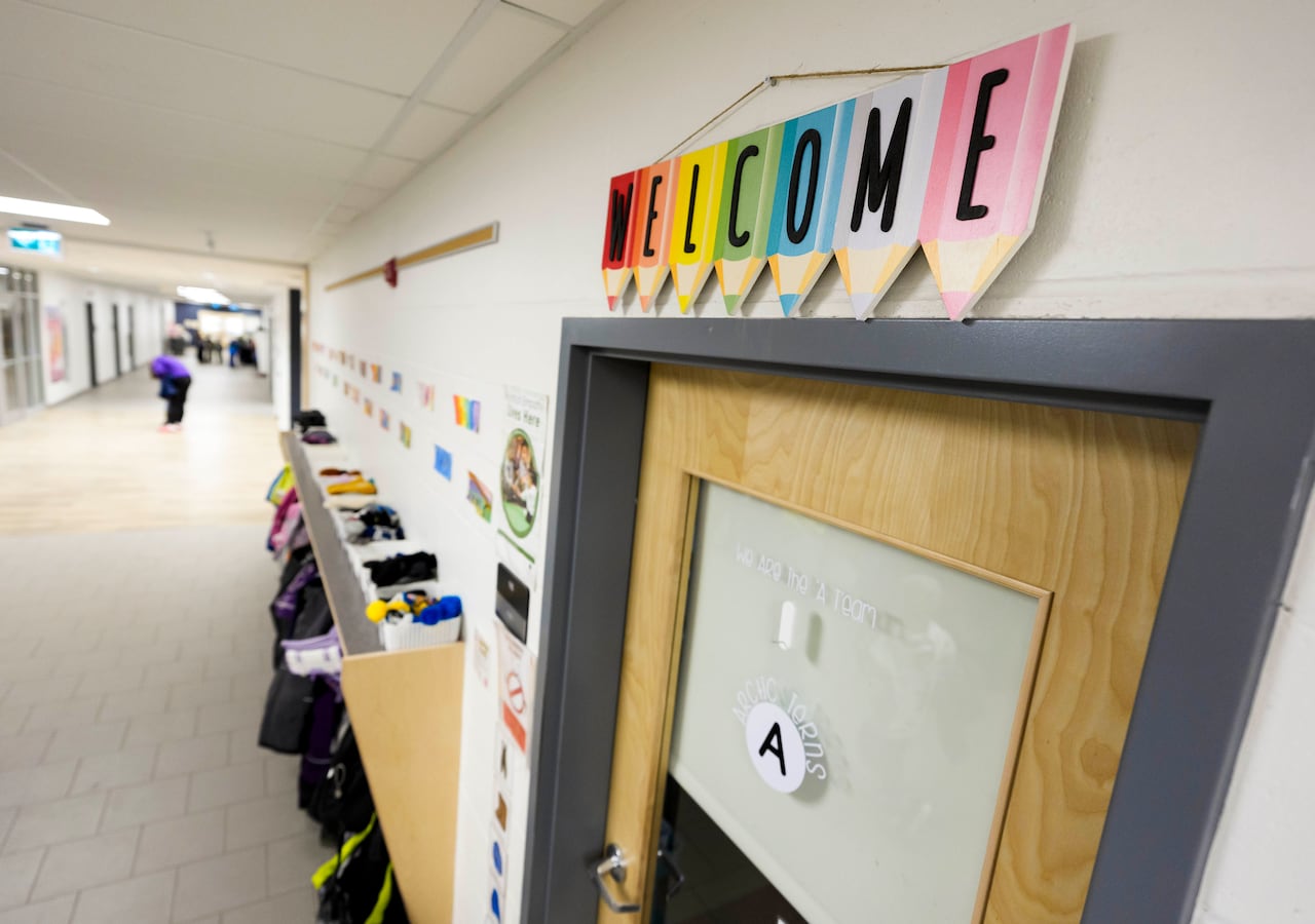 A classroom with a welcome sign above its door.