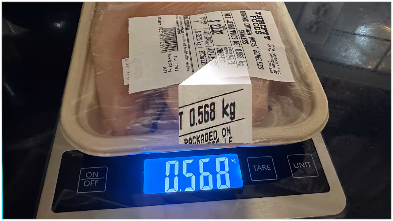 Organic chicken being weighed with a scale. The scale weight and the net weight on the package both show the same amount: .568 kilograms.