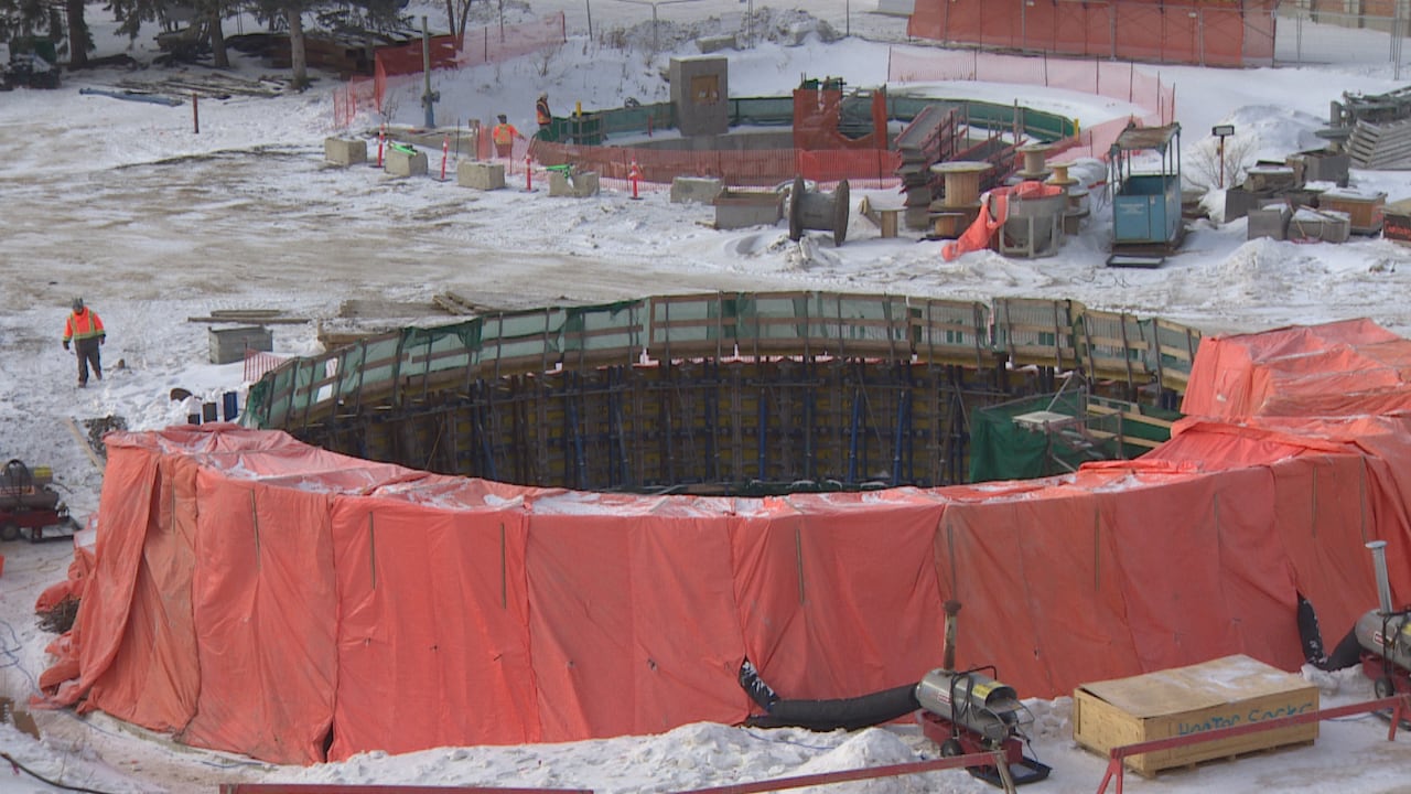 Two large holes can be seen in a construction site.