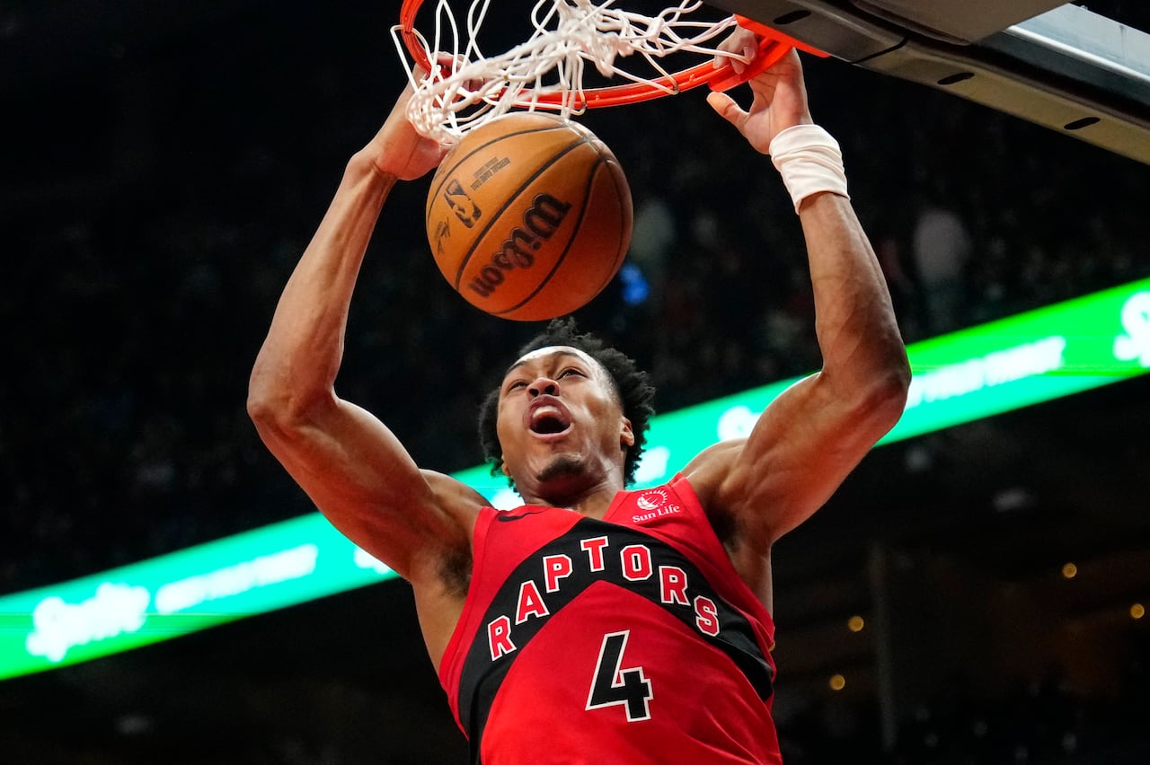Toronto Raptors forward Scottie Barnes in the middle of a slam-dunk