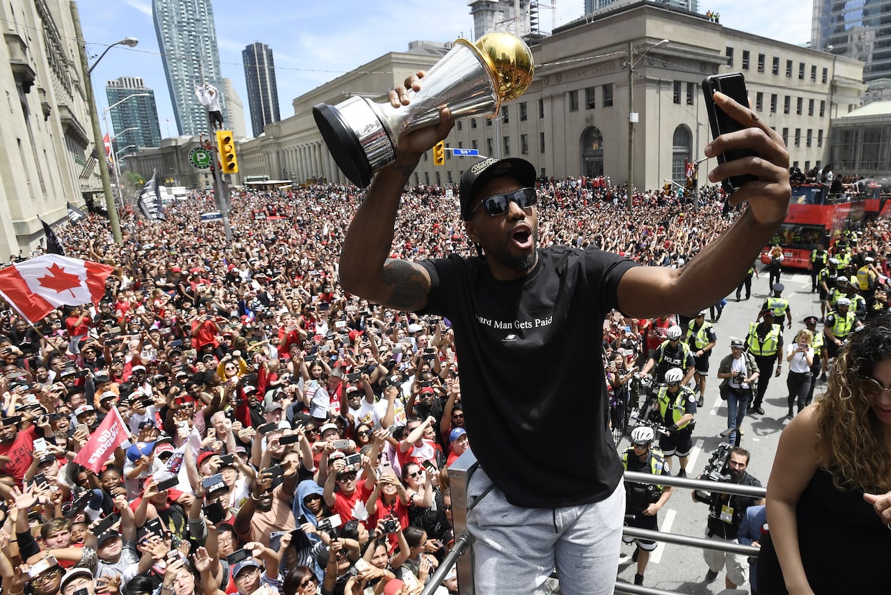 Kawhi Leonard takes a selfie during the Toronto Raptors' championship parade in June 2019