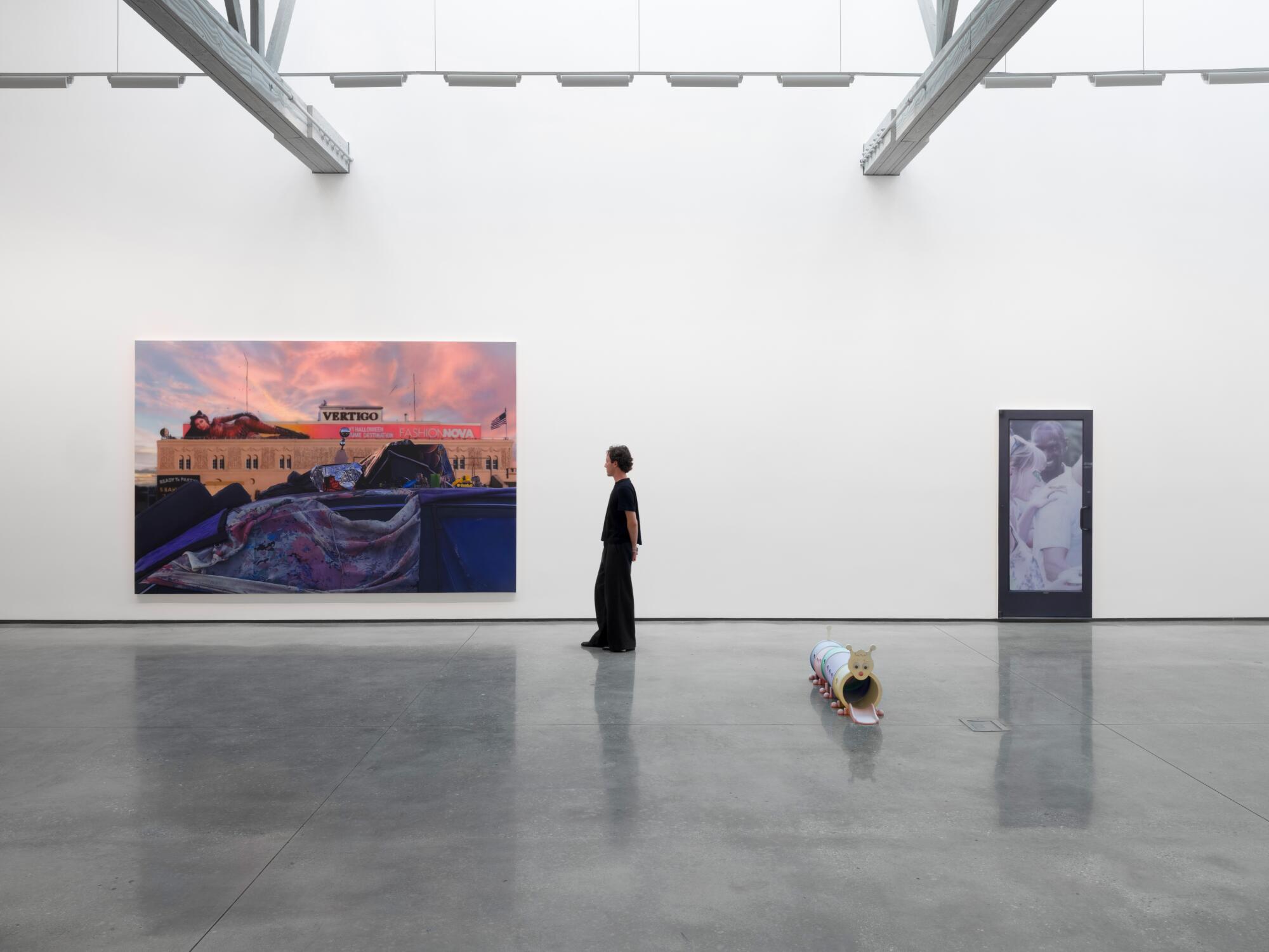 Gallery view with Sayre Gomez's "Vertigo," 2025, acryllic on canvas, 96 x 144 inches in the distance. 