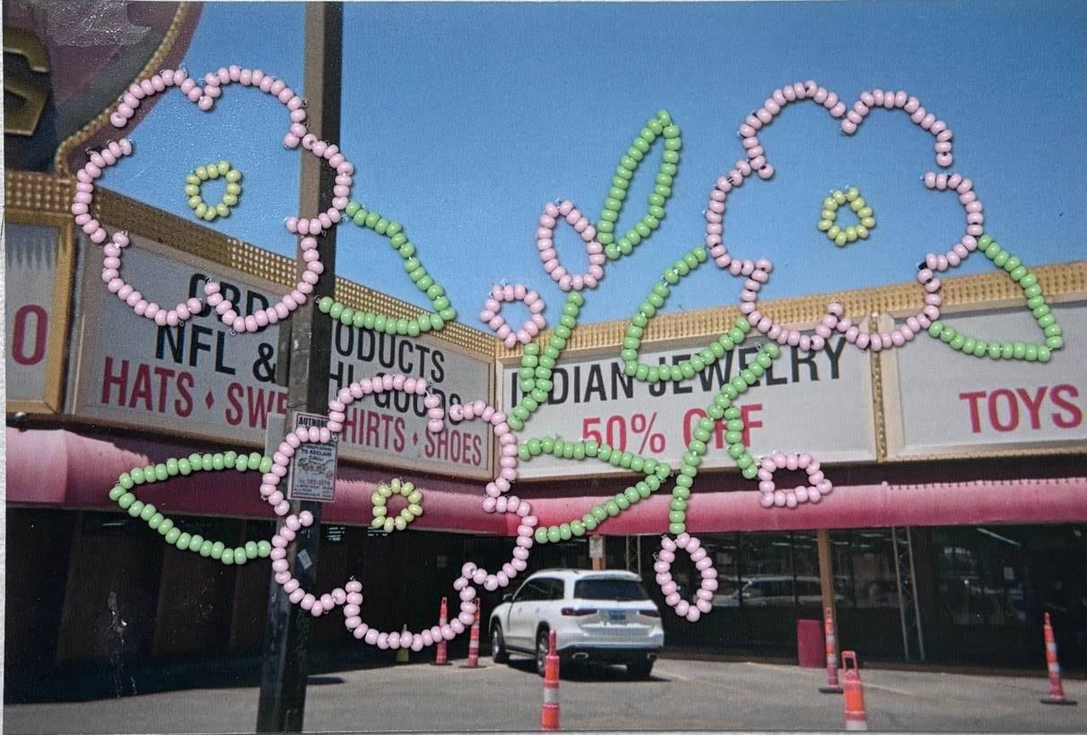 Photo of a stripmall embellished with seed bead design of pink flowers.