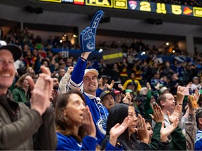 A crowd of Vancouver Canucks fans celebrates a rare 2026 win for the embattled team