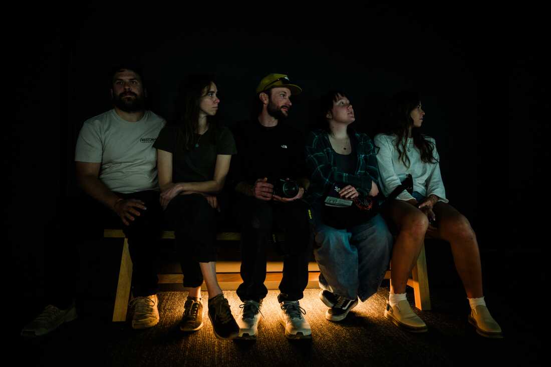 A group of friends sits in The RAF Exhibit Gallery and watch FRAMERATE: Desert Pulse on April 14, 2026 at Desert Botanical Garden in Phoenix, Arizona.