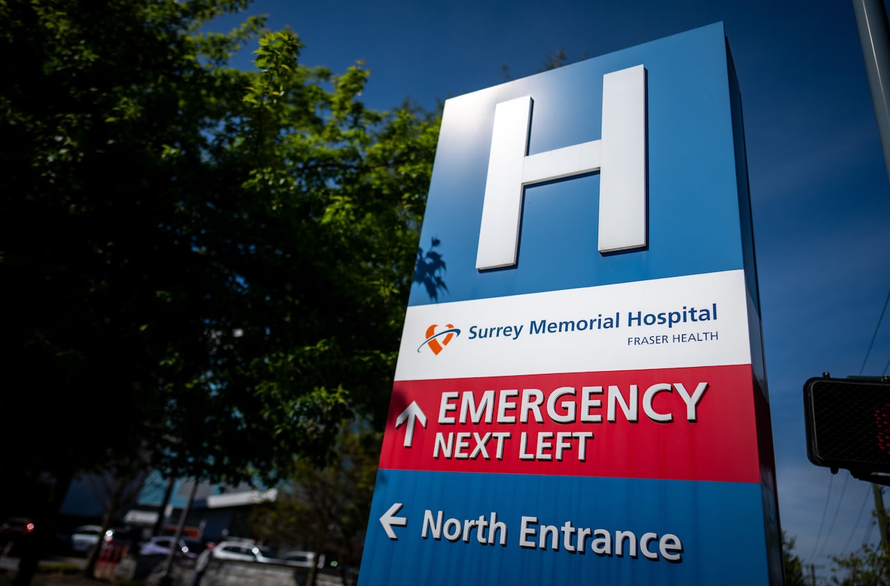A hospital sign with directions for the emergency and north entrance of Surrey Memorial Hospital.