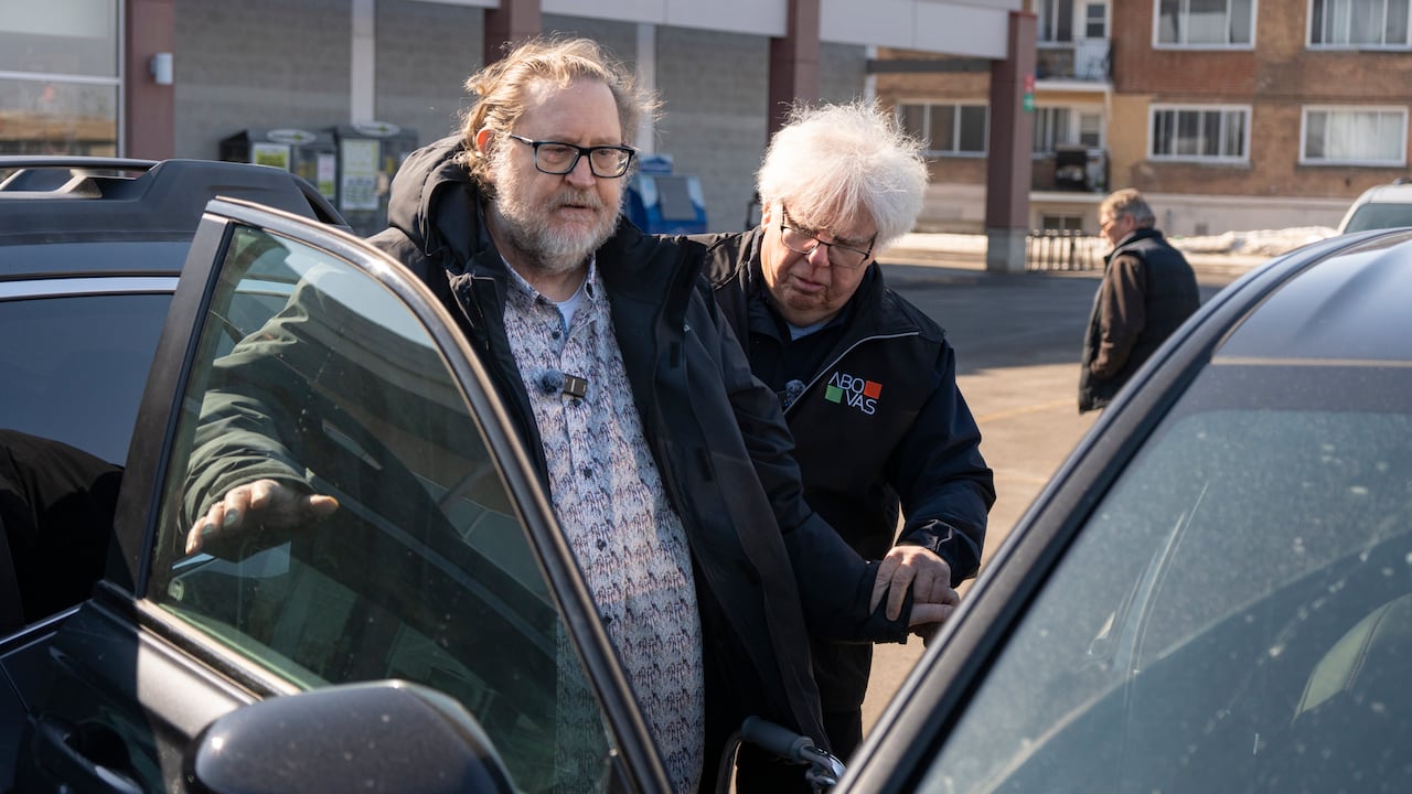 two people outside a car