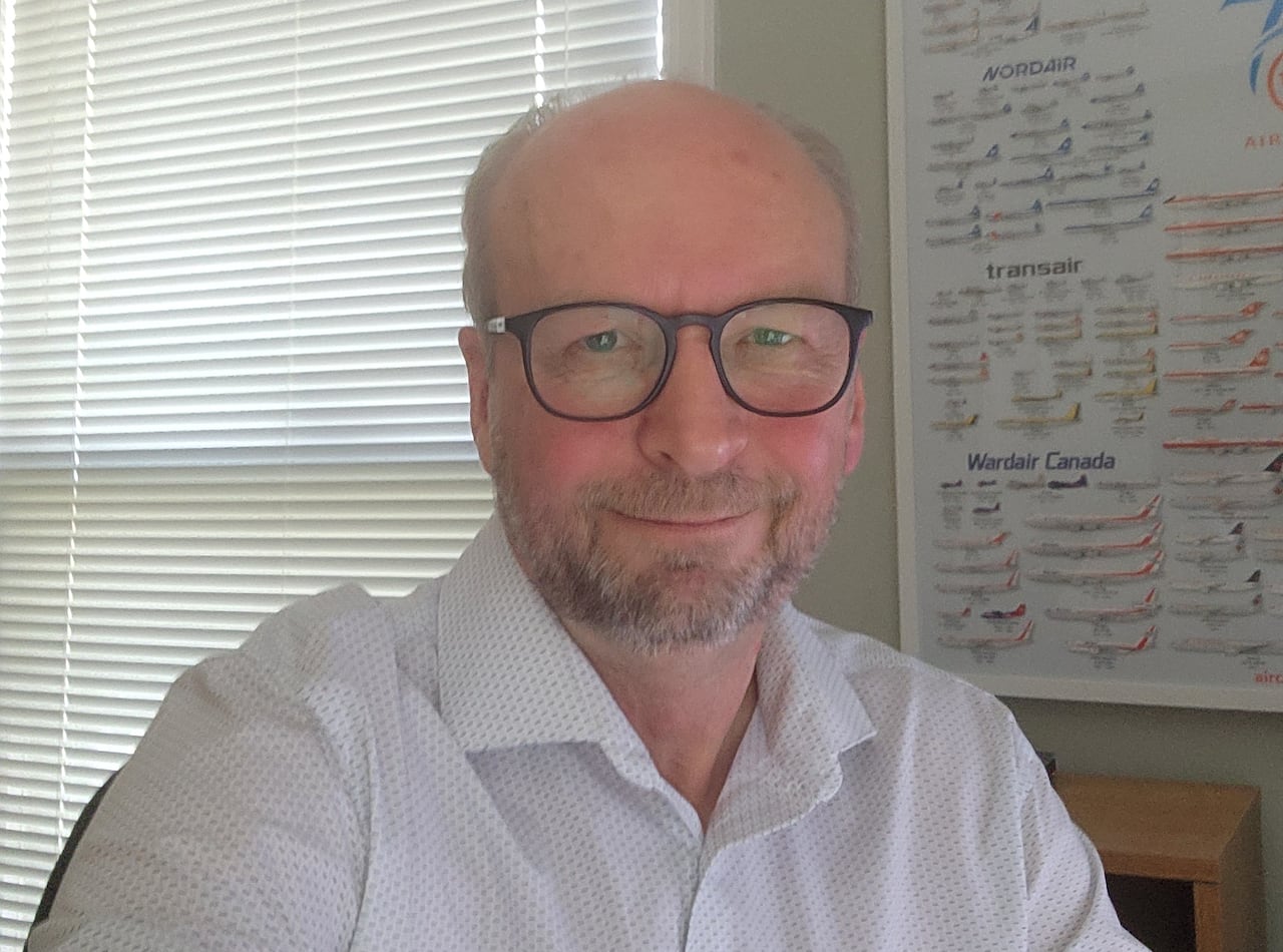 Man in glasses sitting in an office.