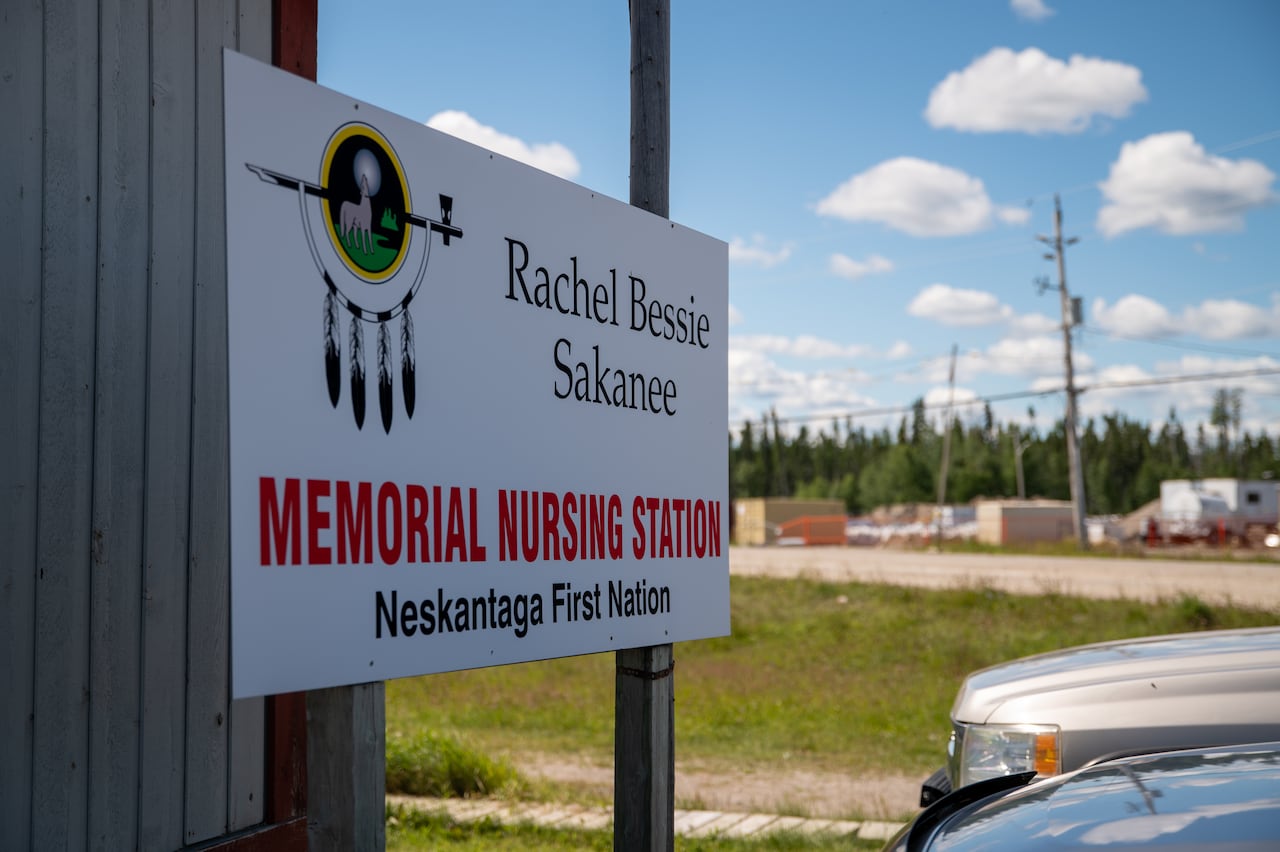 A close-up of a sign that says "Rachel Bessie Sakanee Memorial Nursing Station: Neskantaga First Nation."