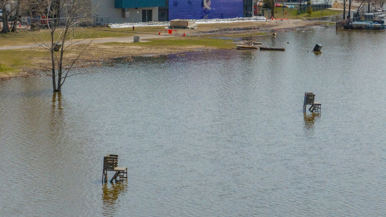 Lifeguard seats sit surrounded by water.