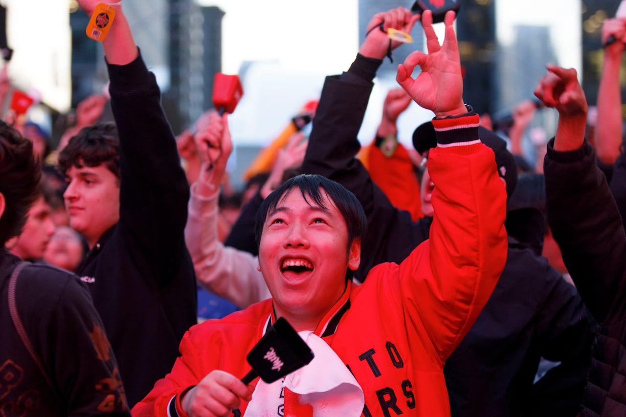 Toronto Raptors fans celebrate at Jurassic Park outside Scotiabank Arena during Game 3 of the first-round NBA playoff series against the Cleveland Cavaliers in Toronto on April 23, 2026.