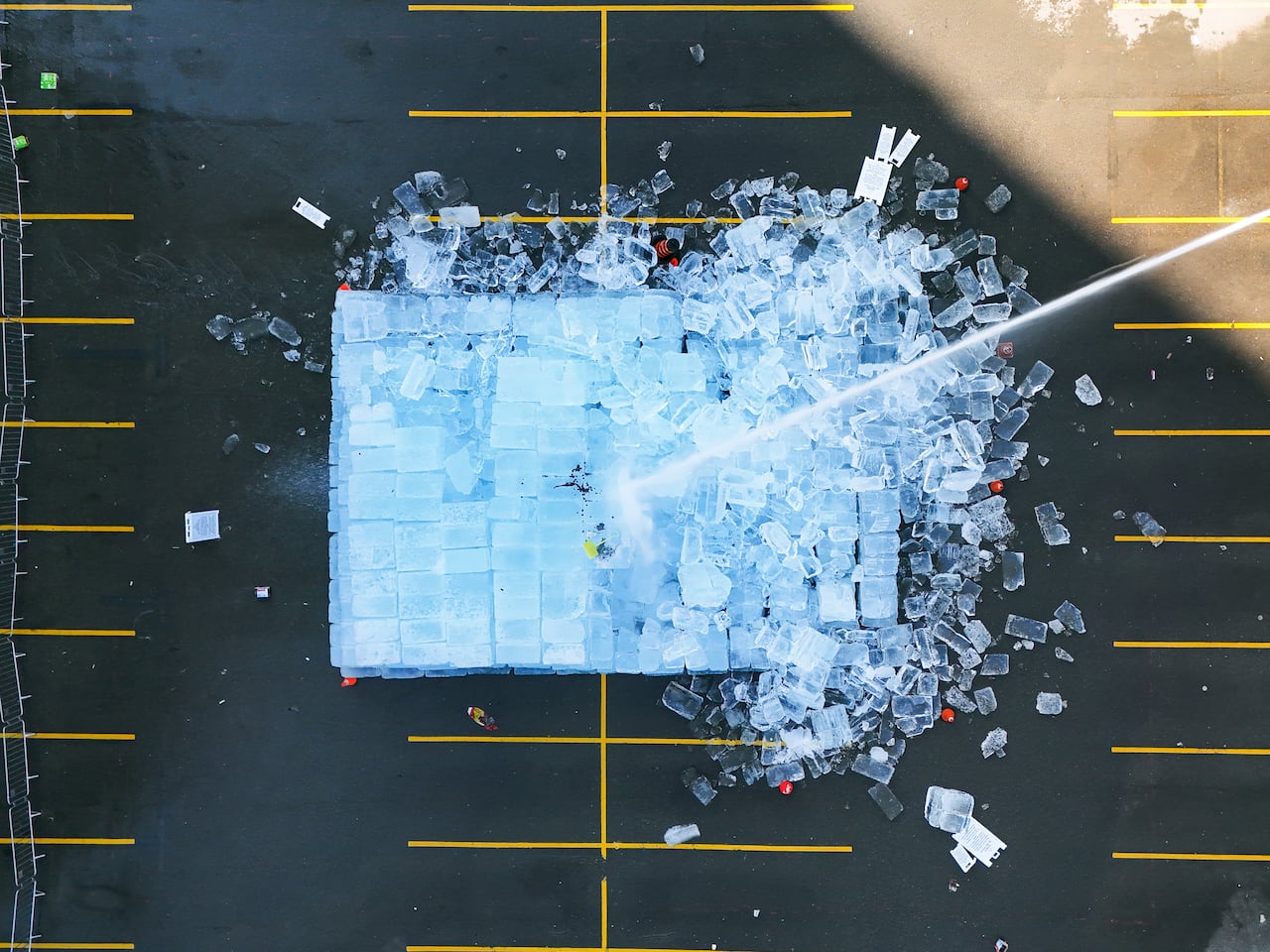 Overhead as water is sprayed on large installatin of ice blocks