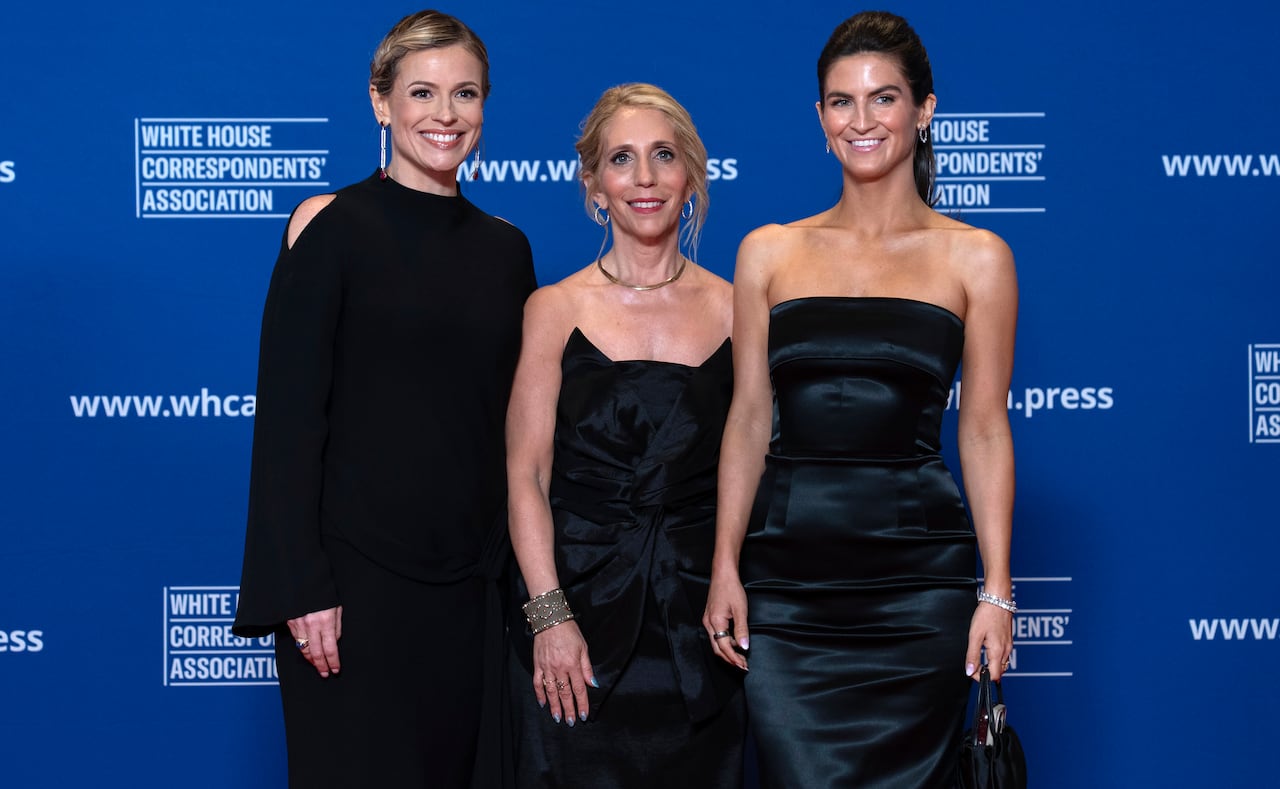 Pamela Brown, Dana Bash and Kaitlan Collins, all wearing formal attire, stand in front of a backdrop saying 'White House Correspondents' Association.