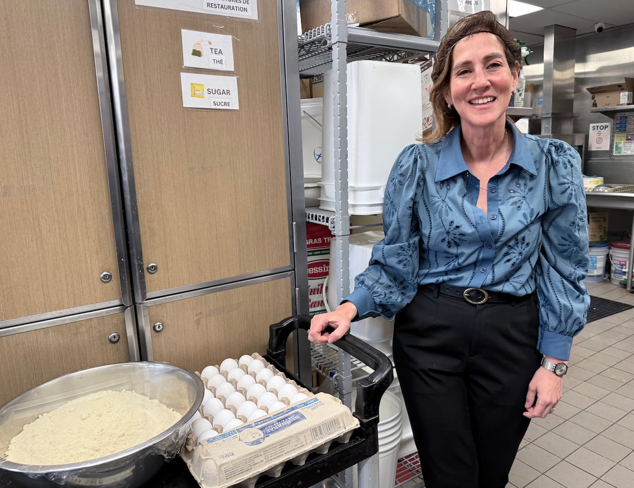 woman standing in kitchen with eggs and flours by her side