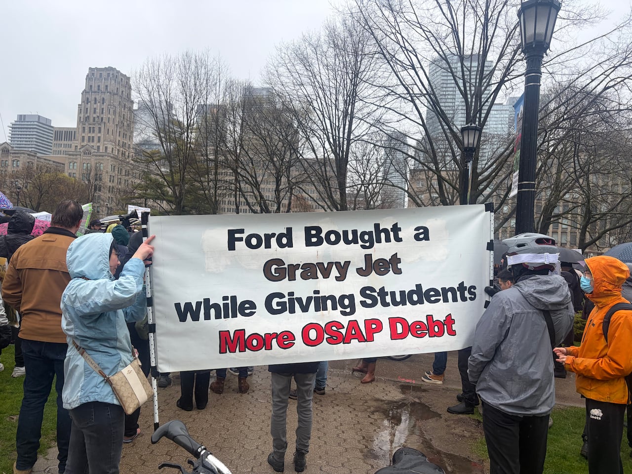 People hold banner at protest