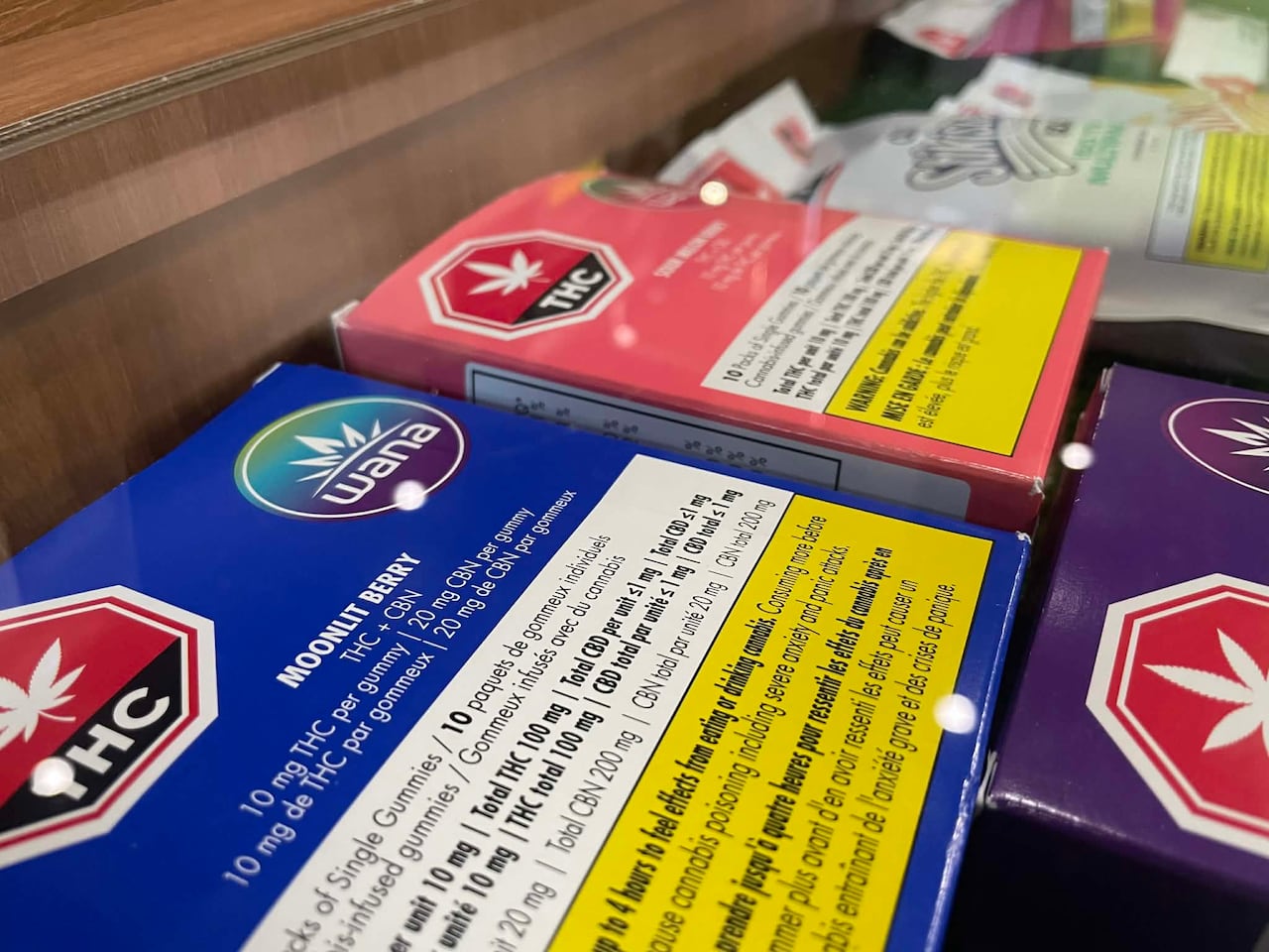 Packages of pot gummies in the display case