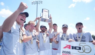 Photo of the men's tennis team and coaches after winning the title