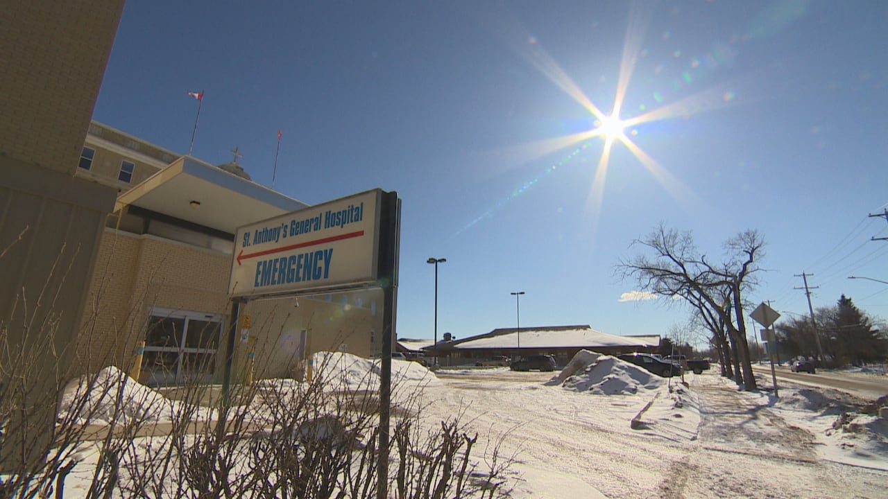 The sun shines brightly in a blue sky above a snow-covered driveway in front of a building. A sign says "St. Anthony's General Hospital Emergency."
