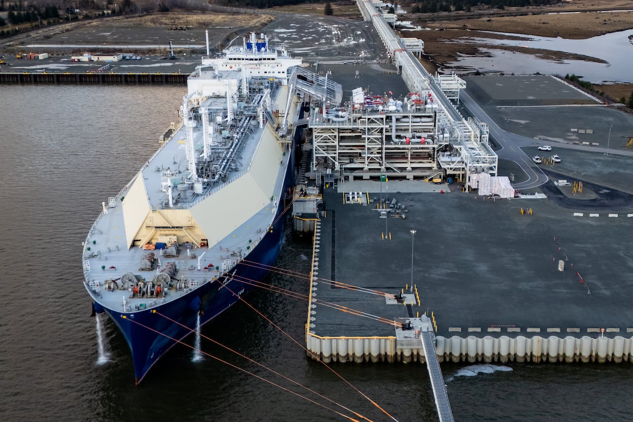 An aerial view of a large ship at an industrial facility.
