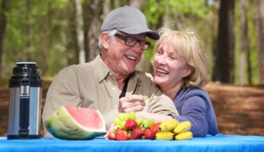 Smiling senior couple enjoying their time at a park for stock photo.