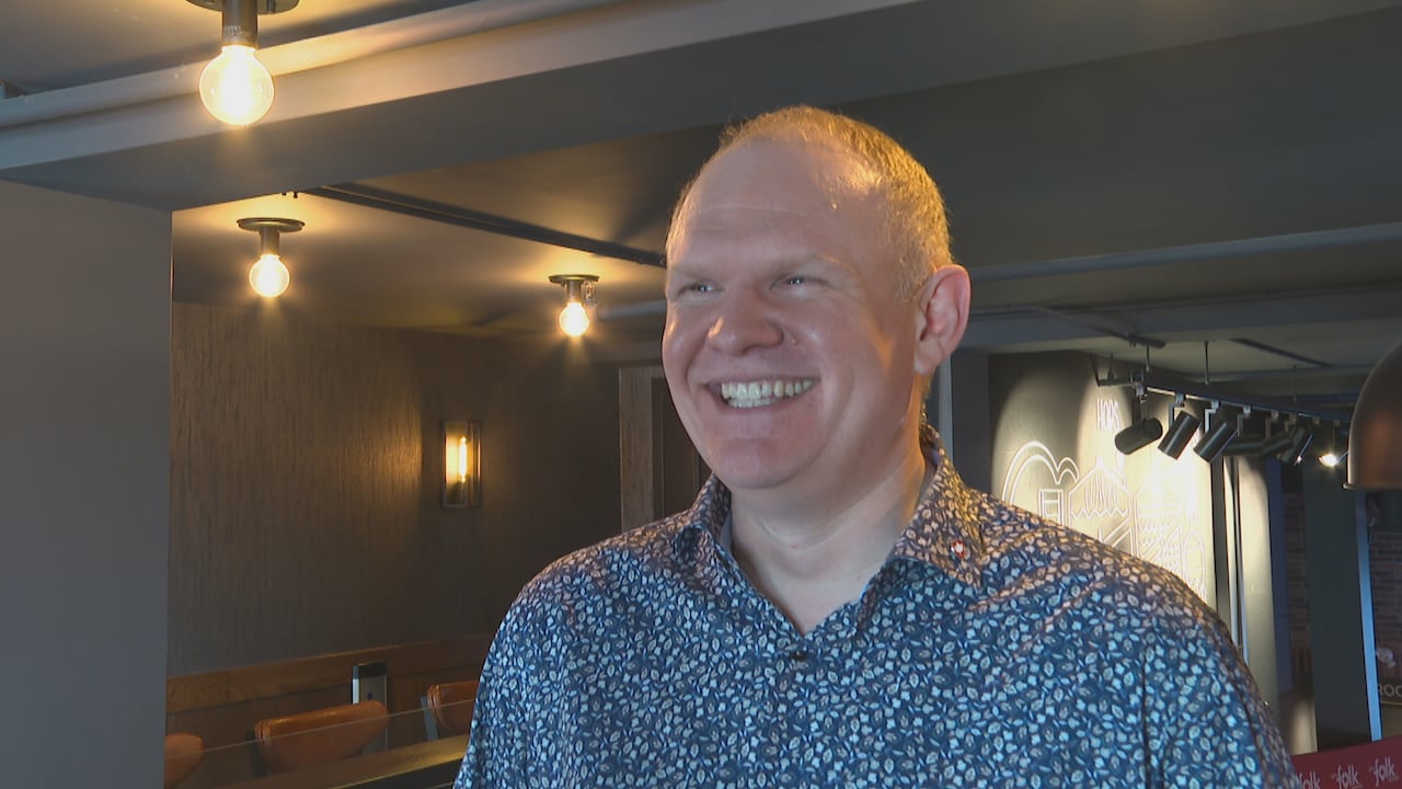 A man smiles for a photo.
