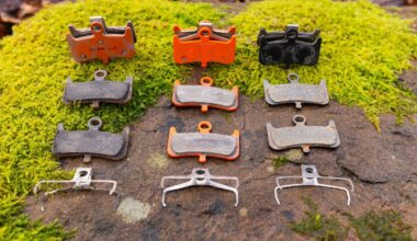 A pair of Gorillia Enduro Pro, Trickstuff Power, and AliExpress Kingstop brake pads lais out on a mossy rock.