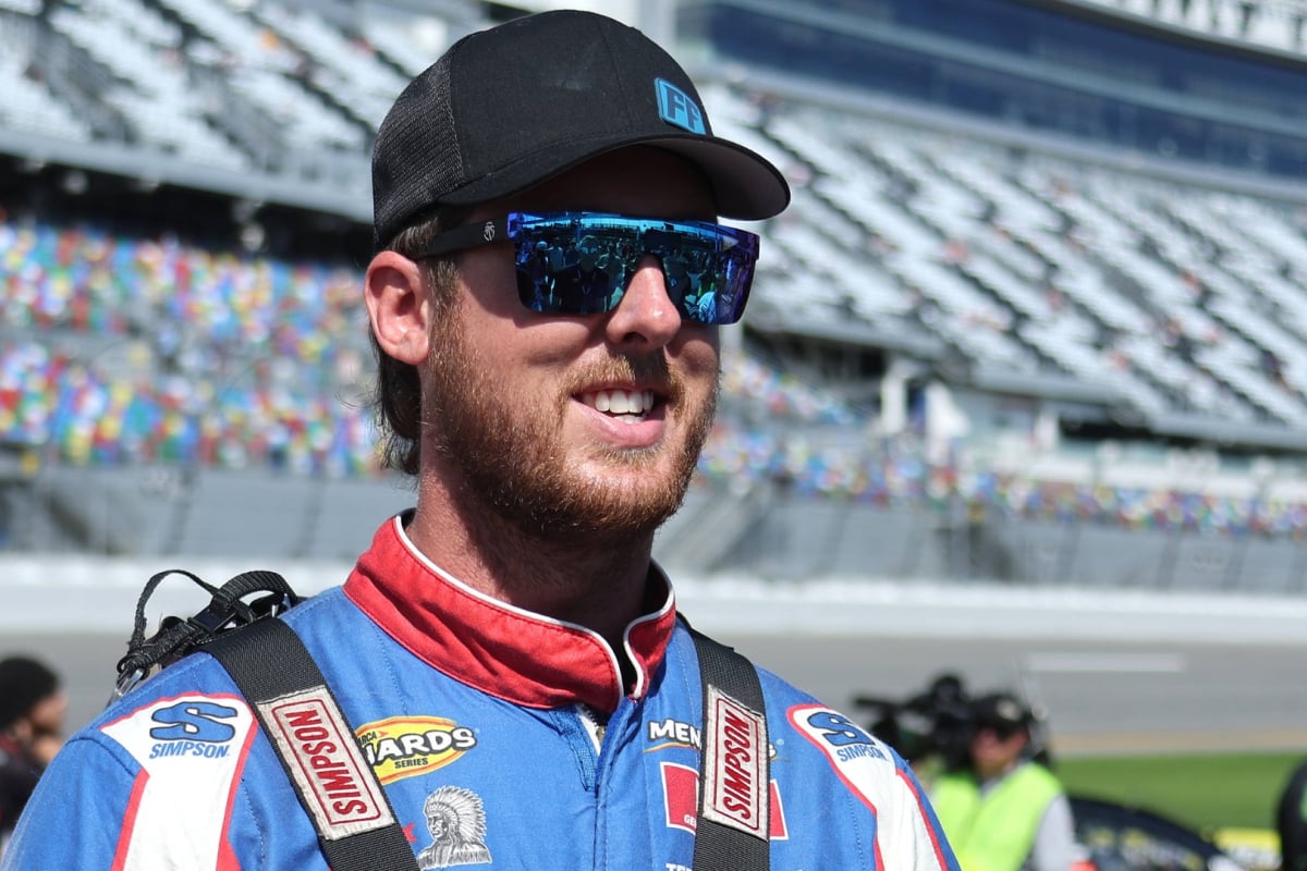 An image of Cleetus McFarland smiling on pit road at Daytona International Speedway