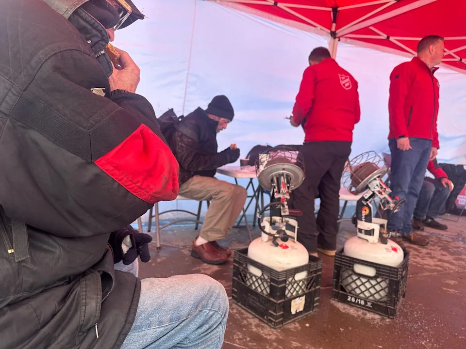 People sit down for food and to warm up on a cold day at one of the Extreme Weather Response program's warming centres near Chinook LRT station.