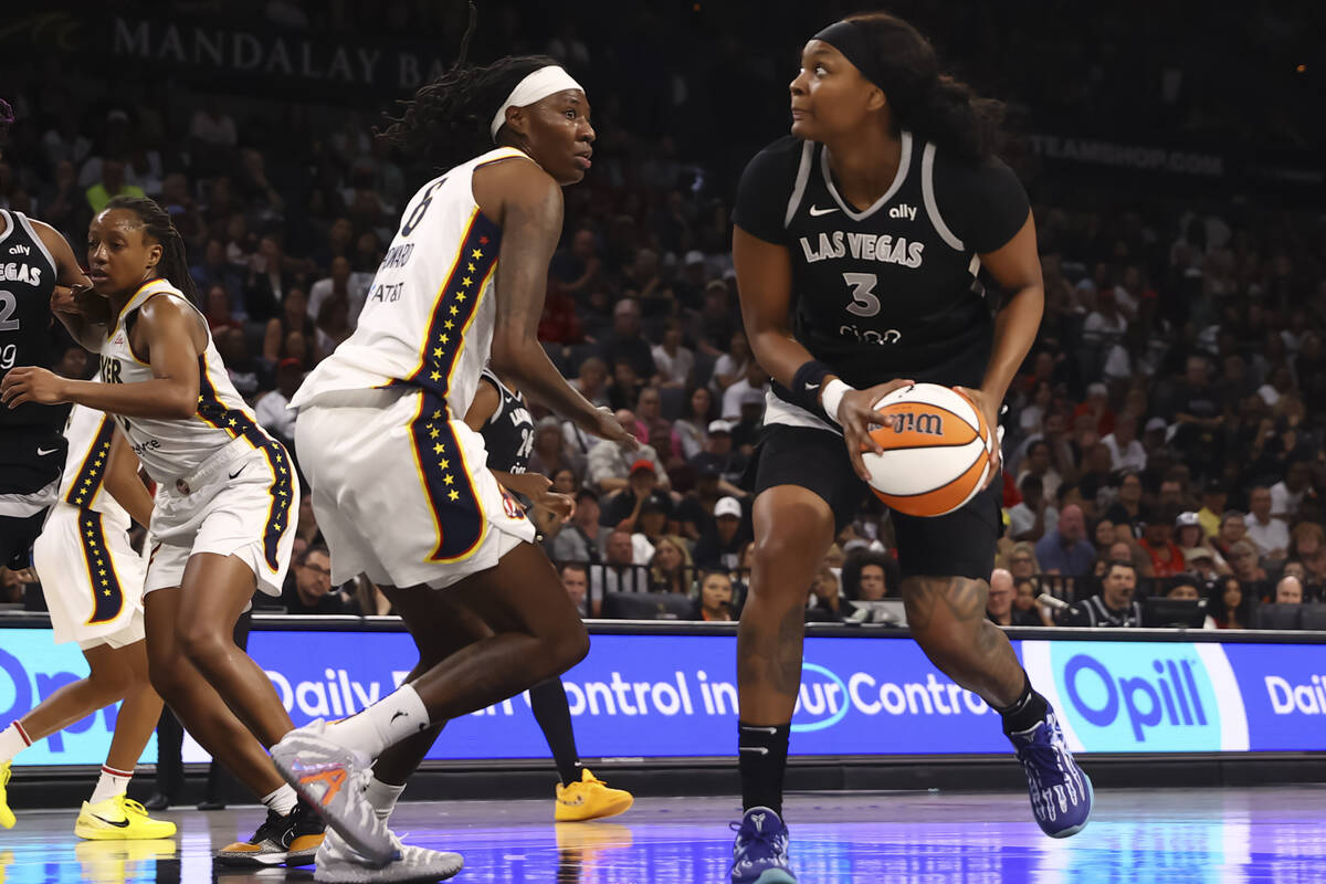 Aces forward NaLyssa Smith (3) looks to shoot against Indiana Fever forward Natasha Howard (6) ...