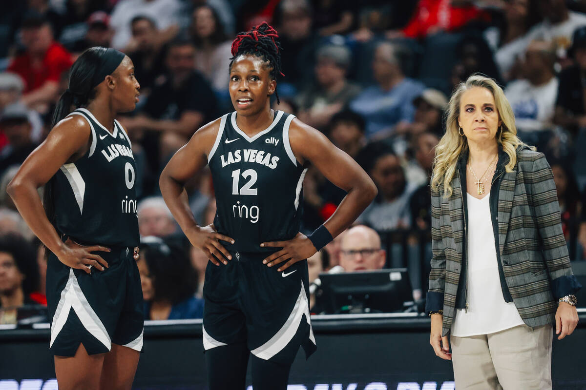 Aces guard Jackie Young (0) and guard Chelsea Gray (12) talk during a free throw next to head c ...