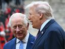 King Charles III and President Donald Trump talk as they inspect a guard of honour during a ceremonial welcome in the Quadrangle at Windsor Castle, in Windsor, on Sept. 17, 2025.