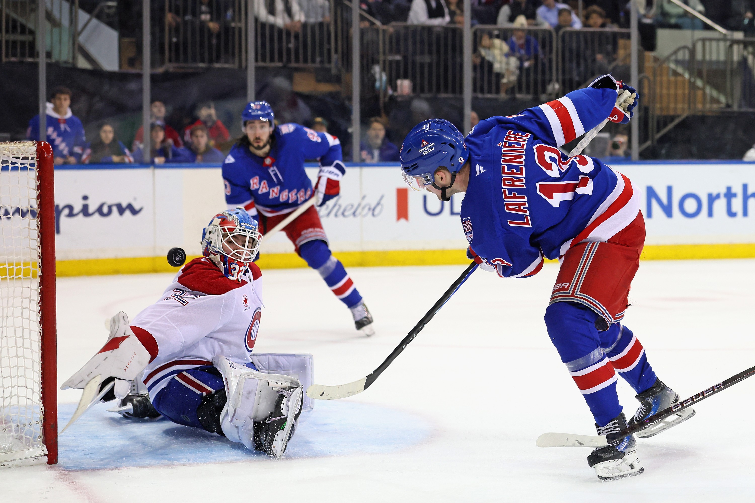 Hockey goalie makes a save. 