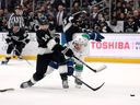 Alex Laferriere #14 of the Los Angeles Kings takes a shot in front of Teddy Blueger #53 of the Vancouver Canucks during the second period at Crypto.com Arena on April 09, 2026 in Los Angeles, California. The Kings won 4-1.