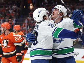 Ty Mueller #39 congratulates Curtis Douglas #42 of the Vancouver Canucks after his first career NHL goal during the first period against the Anaheim Ducks at Honda Center on April 12, 2026 in Anaheim, California.