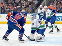 Kevin Lankinen makes a save on Zach Hyman of the Edmonton Oilers during the second period at Rogers Place on Thursday night in Edmonton. The Oilers won 6-1.