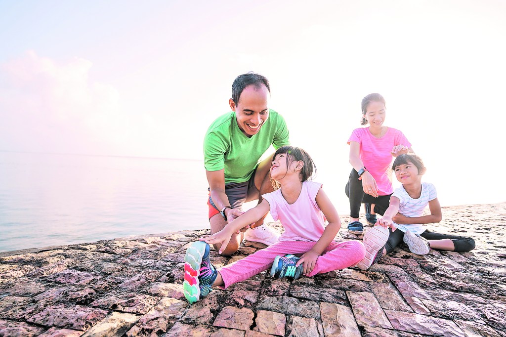 Family of four stretches together