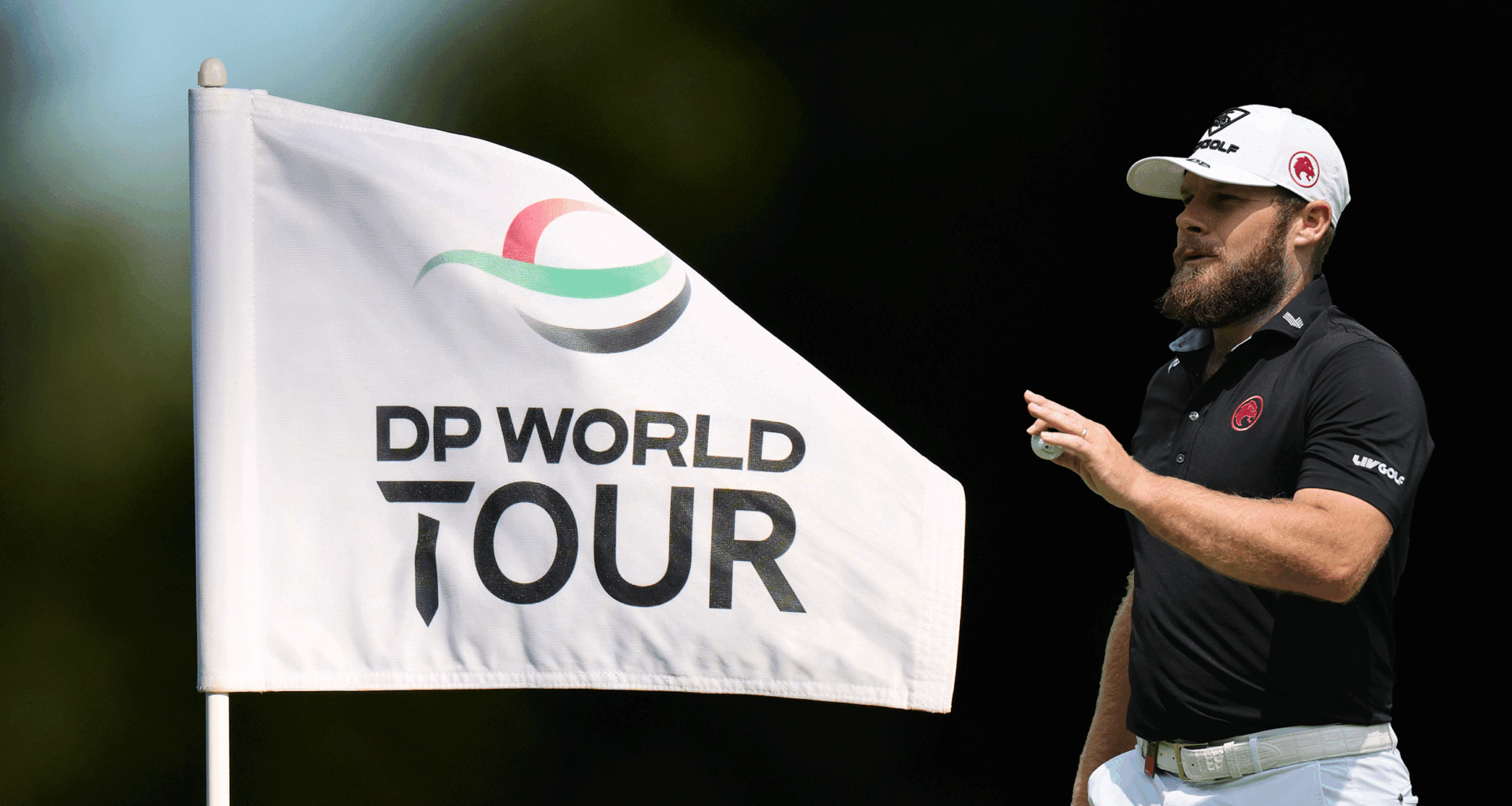 A DP World Tour pin flag and Tyrrell Hatton (right) acknowledging the crowd