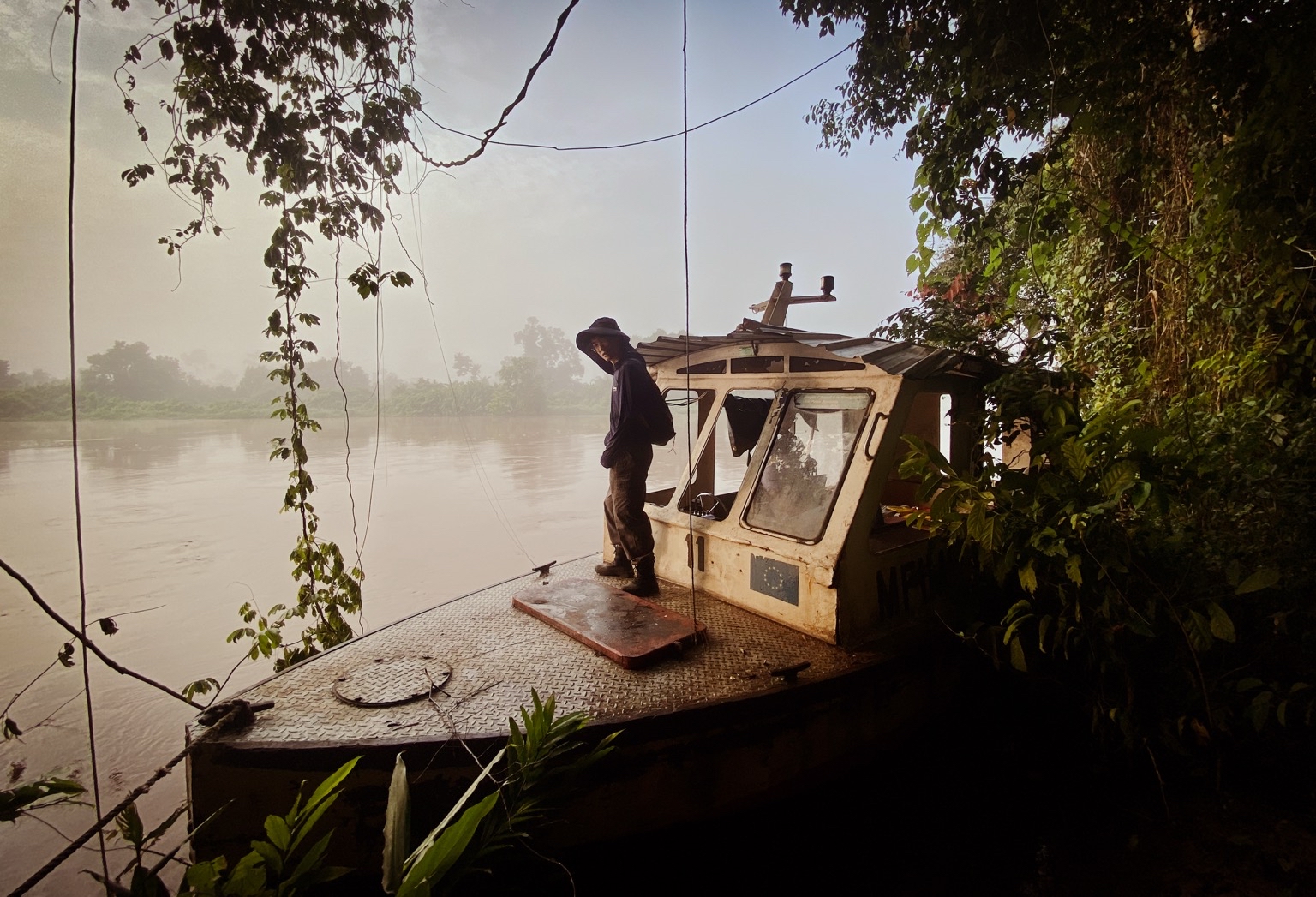 Scientist Pengzhi Zhao gets ready for another day of sampling. Most locations are almost impossible to reach by land. Therefore, small dinghy boats were used to access the remote study sites in the Kasaï River Basin. Image courtesy of Matti Barthel.