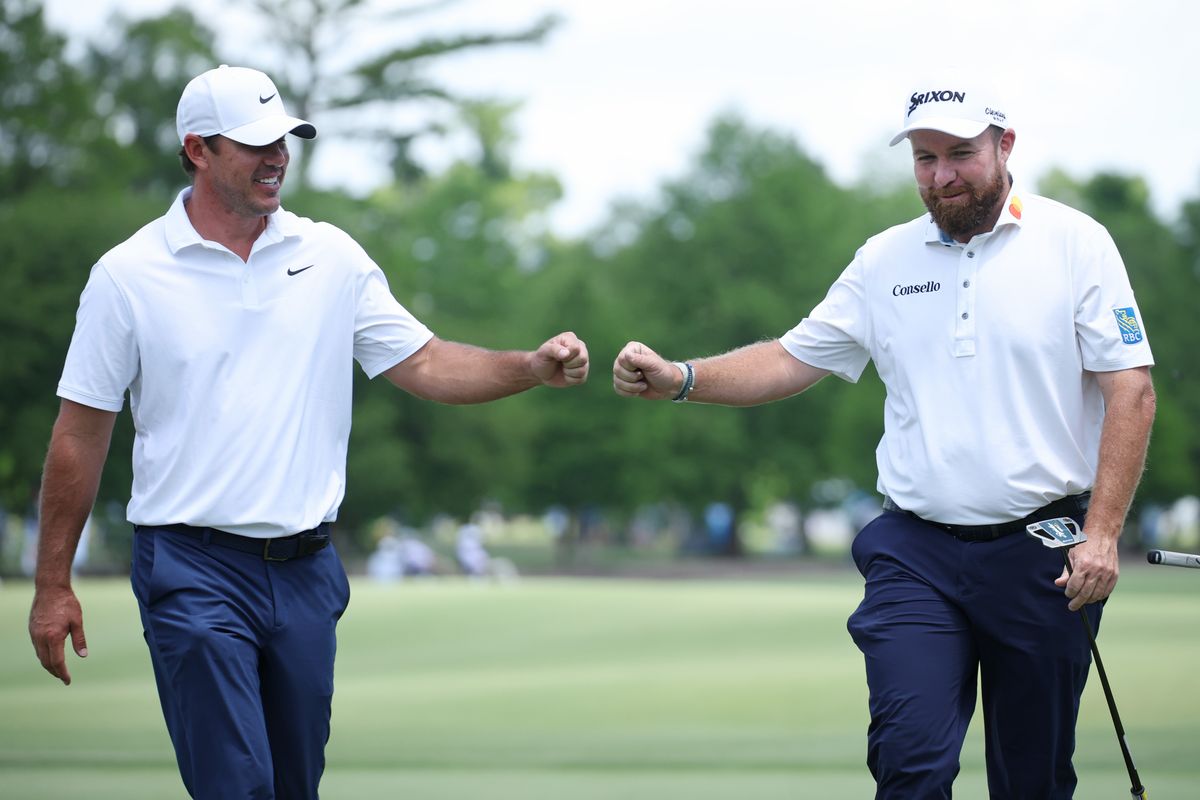 Brooks Koepka and Shane Lowry fist bump