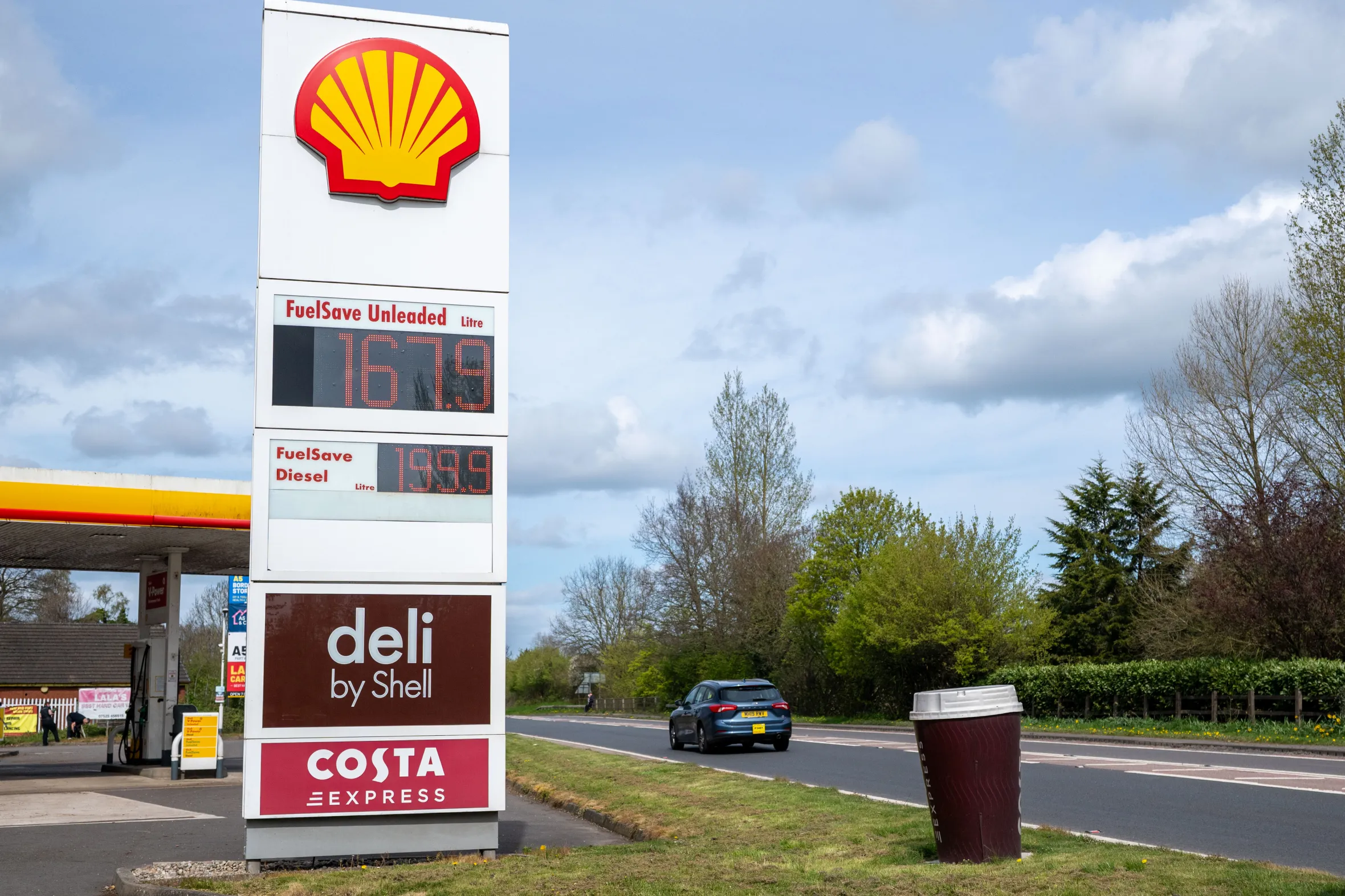 A Shell sign shows petrol priced at £1.67 a litre and diesel at £1.99 a litre.
