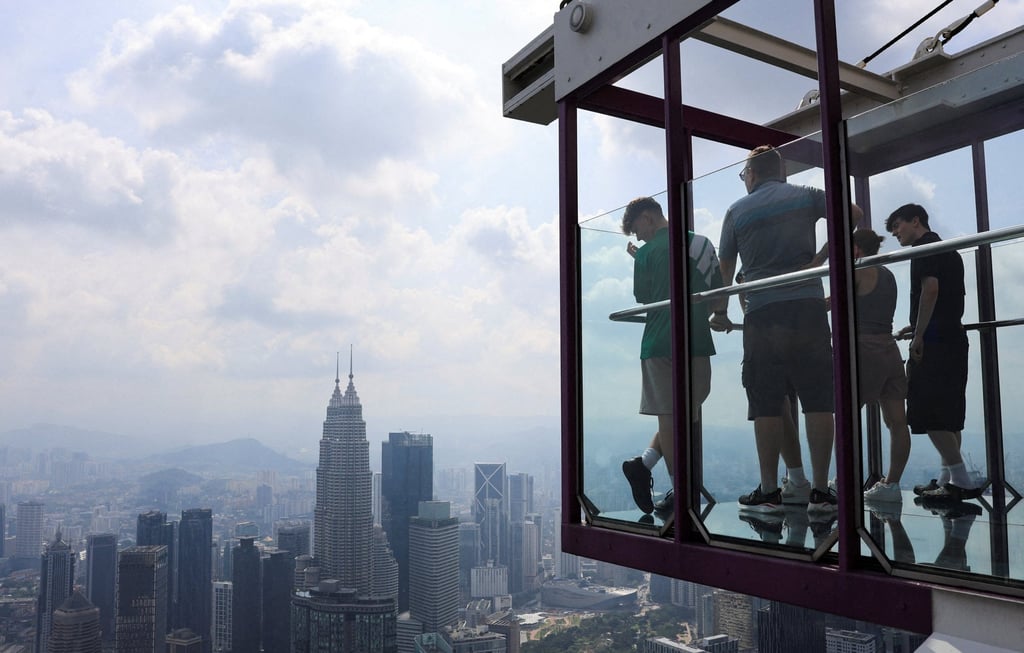 People look at Kuala Lumpur’s skyline from an observation deck on July 31, 2025. Photo: Reuters