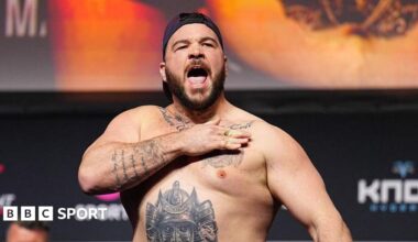 Louie Sutherland slaps his chest as he weighs in