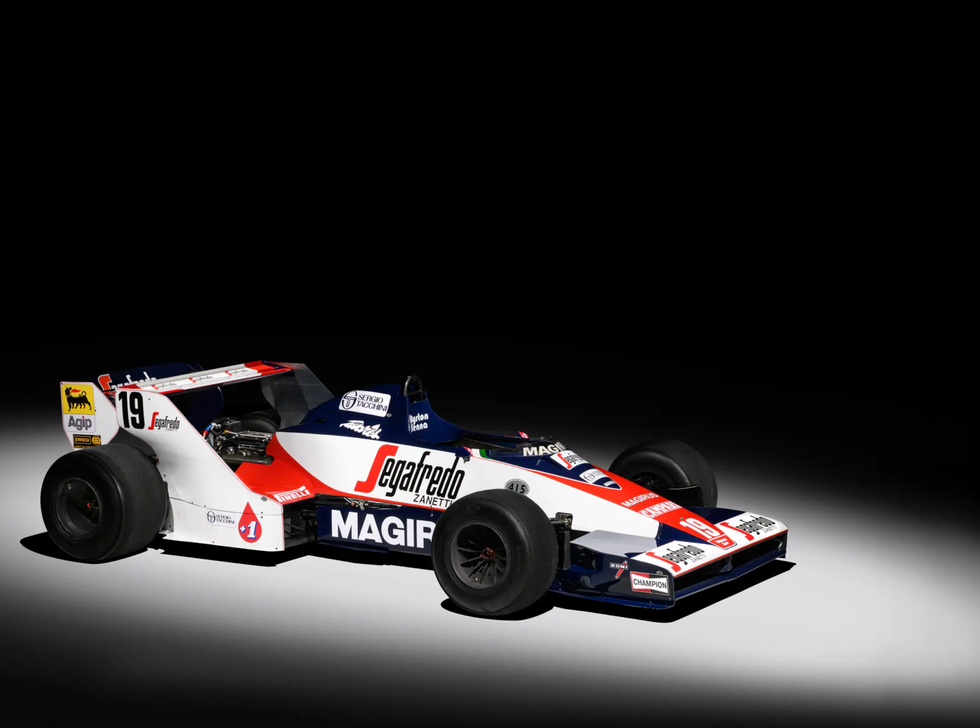 senna's first formula 1 race car featuring bold livery on black background in studio