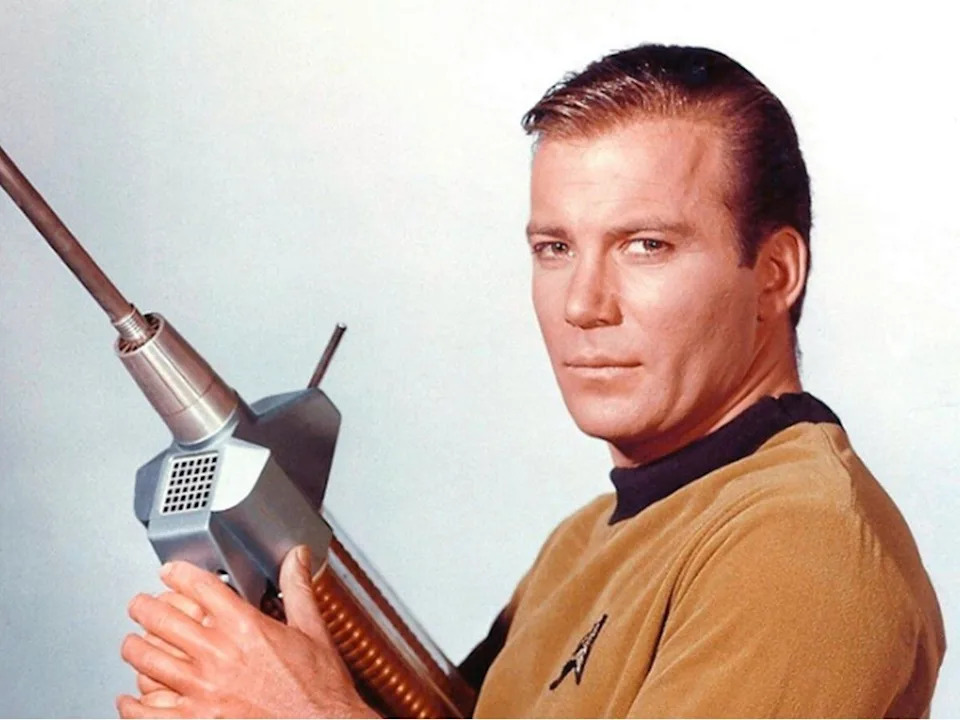  William Shatner as iconic Captain Kirk holding a Star Trek phaser rifle, first seen in the episode, Where No Man Has Gone Before. Photo courtesy, NBC