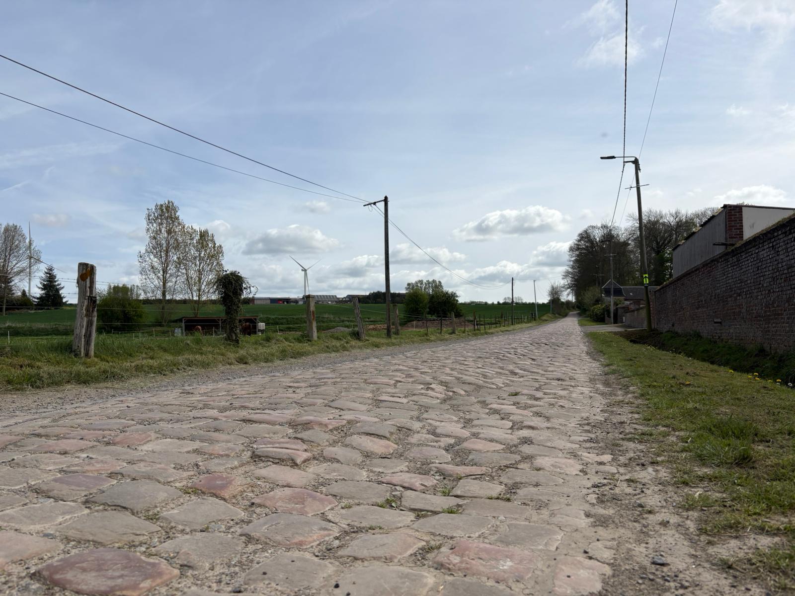 Wide shots of the cobbled section at Briastre, to be used in Paris-Roubaix 2026. The photos show relatively smooth cobbles and a gentle uphill