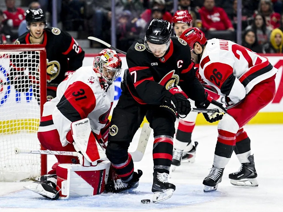  The Ottawa Senators’ Brady Tkachuk tries to the play the puck off his skate in front of Carolina Hurricanes goaltender Frederik Andersen.