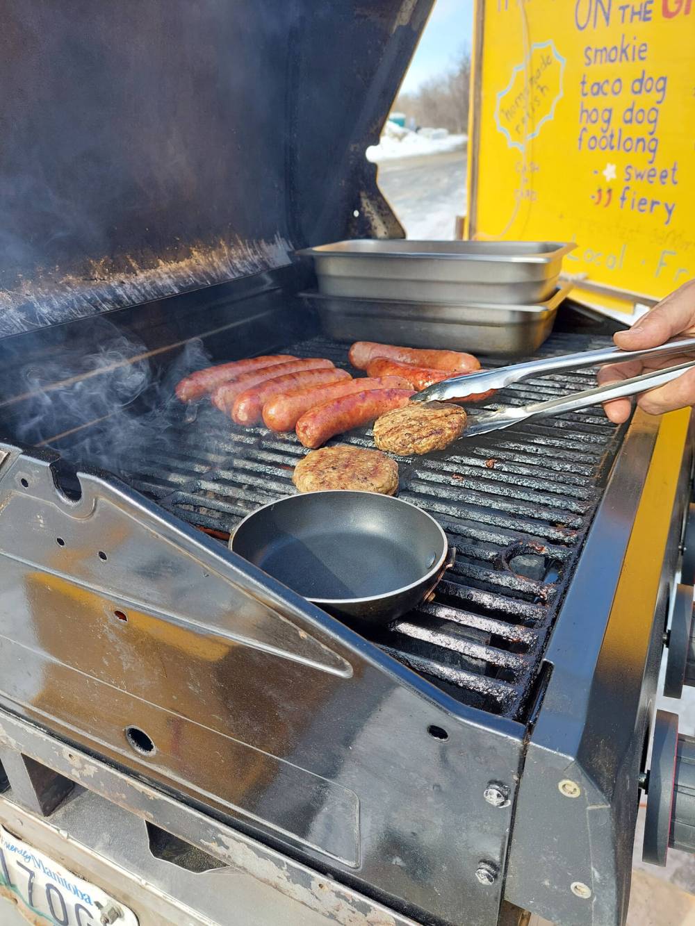 David Sanderson / Free Press
Wall grills his farm’s own pork products.