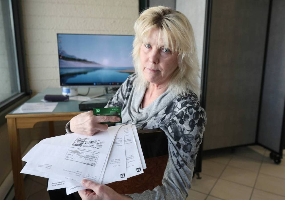 RUTH BONNEVILLE / FREE PRESS
Lisa Taron with photocopies of the 21 fake cheques used in an ATM to steal money from her bank account.