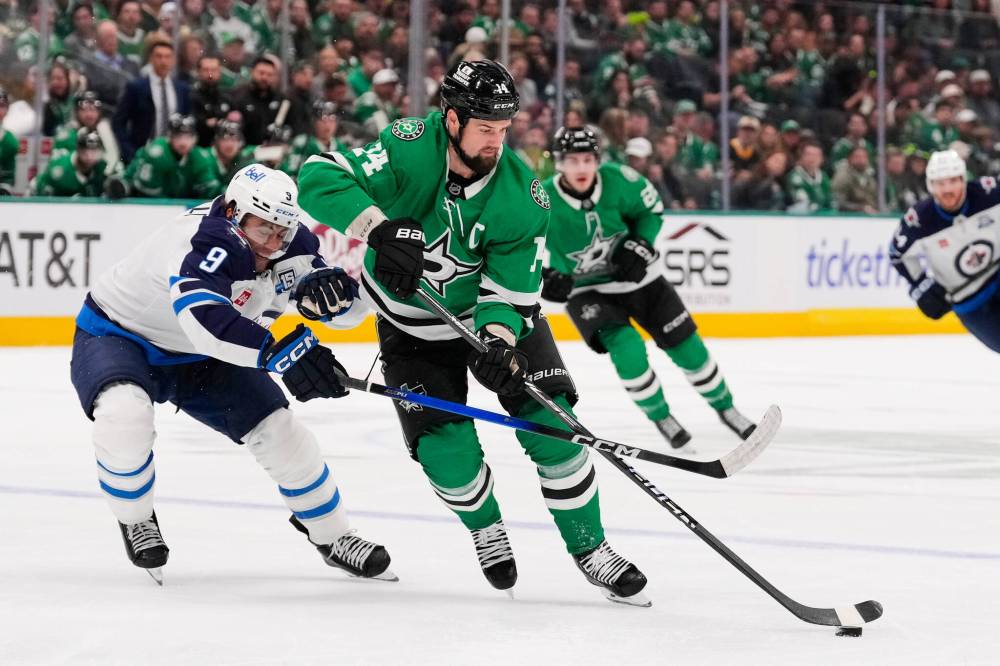 TONY GUTIERREZ / THE ASSOCIATED PRESS
Dallas Stars left wing Jamie Benn (14) takes control of the puck in front of Winnipeg Jets’ Alex Iafallo (9) in the first period of Thursday’s game in Dallas.